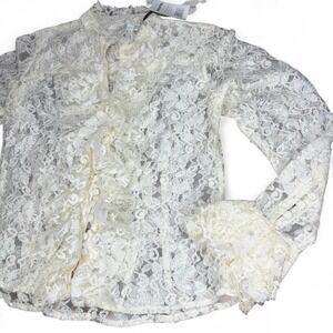 White lace‎ blouse with ruffle details and button